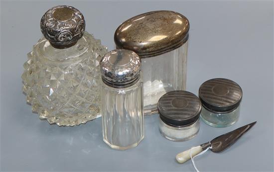 A silver-mounted scent bottle, four other toilet jars and a trowel book mark.